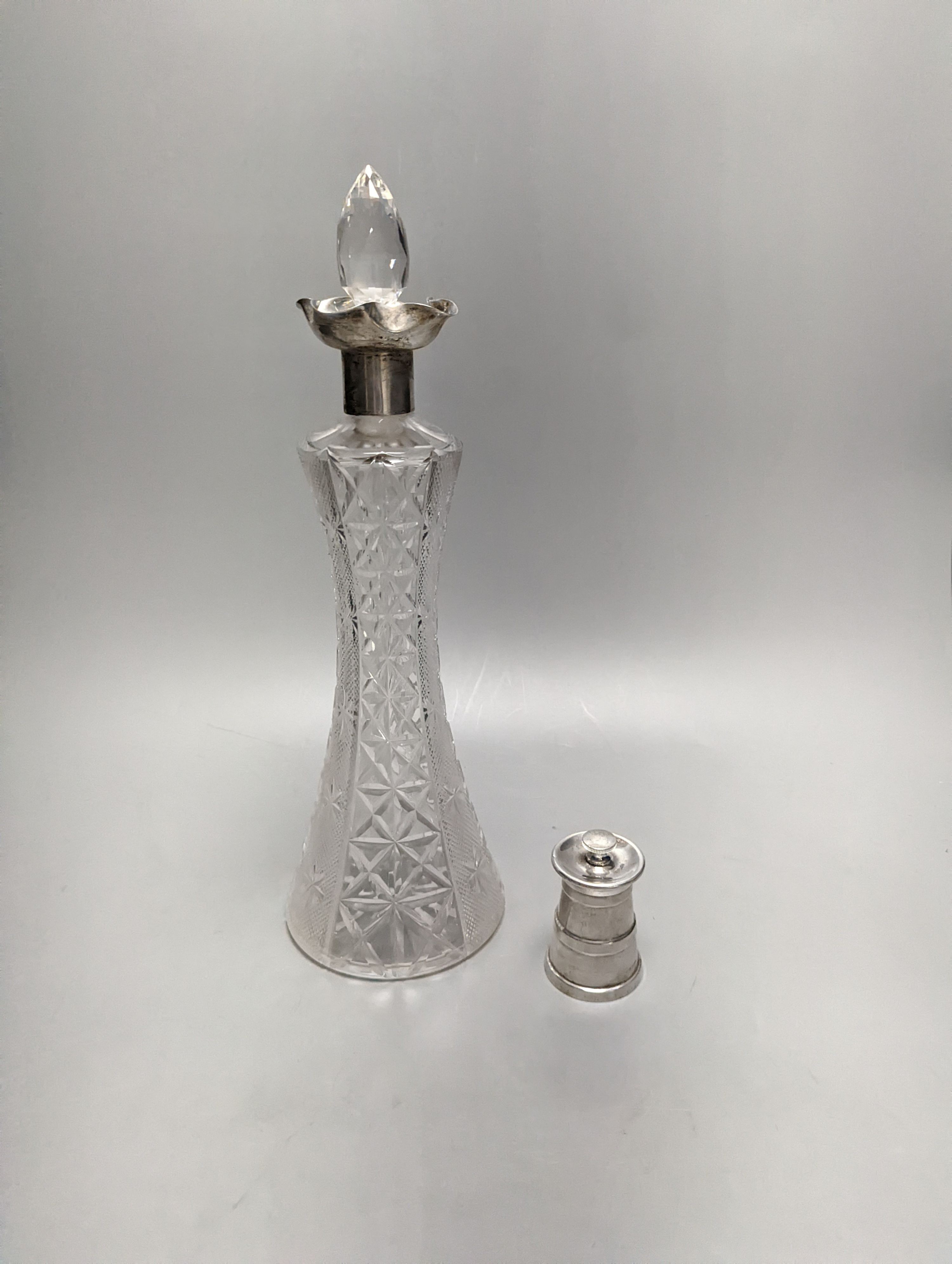 An Edwardian silver mounted cut glass decanter, Sheffield, 1903, 36cm and silver mounted pepper mill.